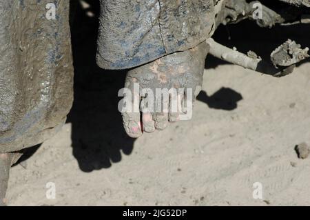 People with 4 wheelers and trucks on Sunday outing in the mud for fun and show of power and speed North FL feet toes dirt Stock Photo
