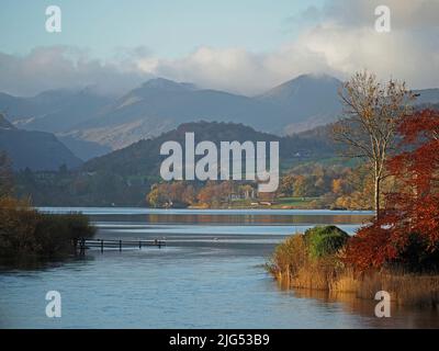 Autumn landscape view from Pooley Bridge across calm waters of Ullswater with soft clouds over dappled lakeland hills in Cumbria, England, UK Stock Photo