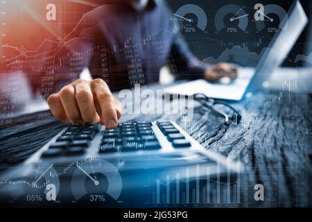 Midsection Of Businessman Calculating Tax Using Calculator With Laptop On Desk In Office Stock Photo