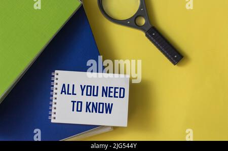 All you need to know is the concepts written in a notepad. There is a magnifying glass and folders with documents on the table Stock Photo