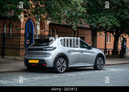 Peugeot e208 GT Electric Vehicle at Charging Point Stock Photo