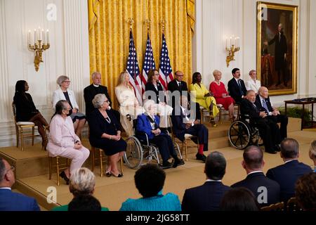 Sixteen of the seventeen Medal of Freedom recipients listen to United States President Joe Biden during a ceremony in the East Room of the White House in Washington, DC on Thursday, July 7, 2022. From left to right, back row: Simone Biles, Sister Simone Campbell, Father Alexander Karloutsos, Gabby Giffords, Khizr Khan, Sandra Lindsay, Cindy McCain, Richard Truck jr, Megan Rapinoe. From left to right, front row: Diane Nash, Julieta Garcia, Wilma Vaught, Fred Gray, Raul Yzaguirre, Alan Simpson. Actor Denzel Washington was unable to appear and will accept the award at a later date. Credit: Chris Stock Photo