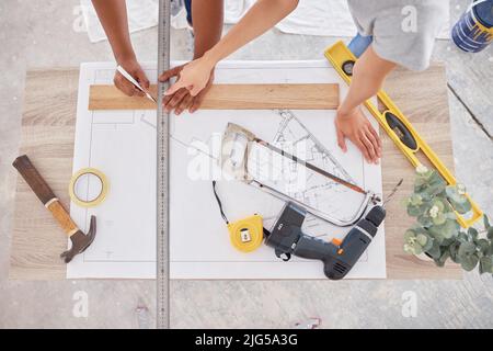 Weve divided our entire renovation into sub-plans. Shot of two people discussing a blueprint. Stock Photo