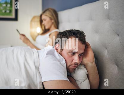There is no such thing as privacy anymore. Shot of a young woman using a cellphone after an argument with her husband. Stock Photo