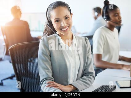 Ive got the answers you need. Cropped portrait of an attractive young female call center agent working in her office. Stock Photo