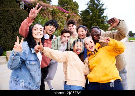 Big group of cheerful Motivated and excited young friends taking selfie portrait. Happy people looking at the camera smiling. Concept of community Stock Photo