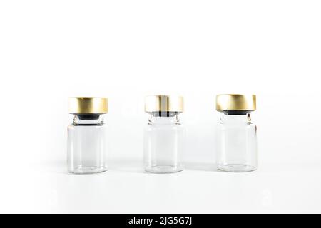 Three small empty glass vials on a white background. Medicine bottles. Copy space Stock Photo