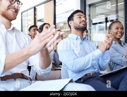 Awesome presentation. Cropped shot of a group of businesspeople applauding during a seminar in the conference room. Stock Photo
