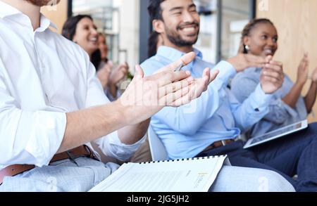 Nicely done. Cropped shot of a group of businesspeople applauding during a seminar in the conference room. Stock Photo