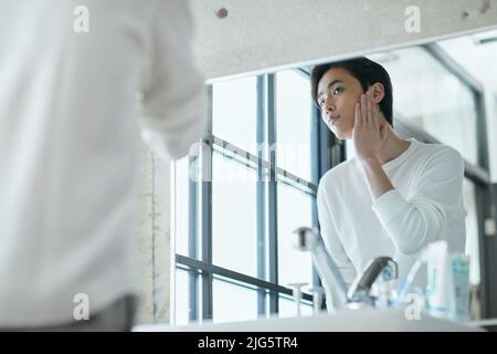 Japanese man doing skincare Stock Photo