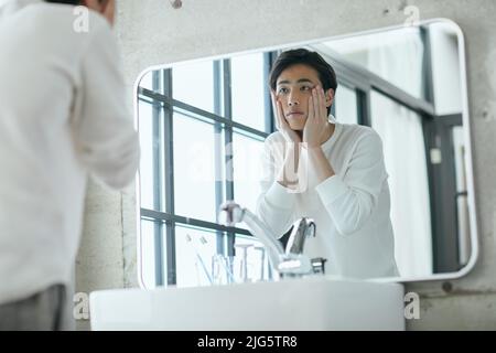 Japanese man doing skincare Stock Photo