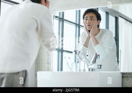 Japanese man doing skincare Stock Photo