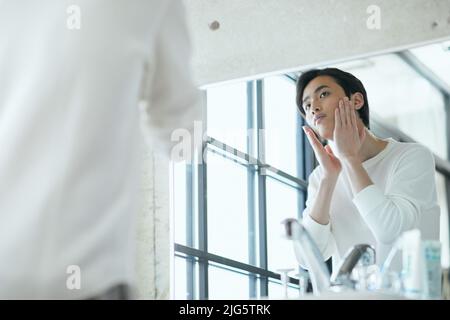 Japanese man doing skincare Stock Photo