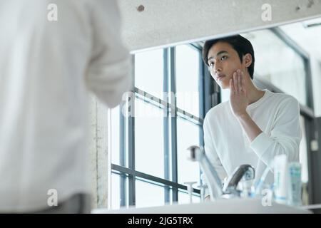 Japanese man doing skincare Stock Photo