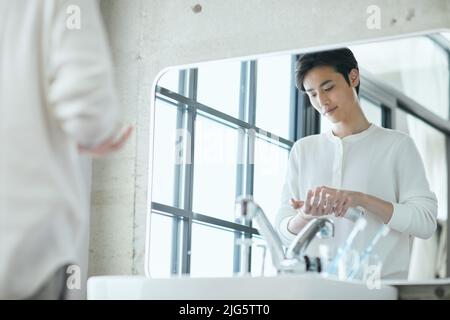 Japanese man doing skincare Stock Photo