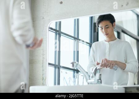 Japanese man doing skincare Stock Photo