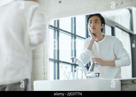 Japanese man doing skincare Stock Photo