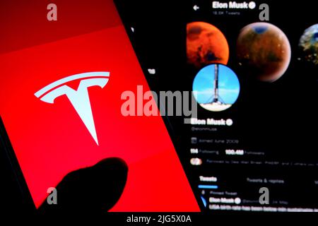 India. 07th July, 2022. In this photo illustration, a Tesla logo seen displayed on a smartphone with Elon Musk Twitter page in the background. Credit: SOPA Images Limited/Alamy Live News Stock Photo