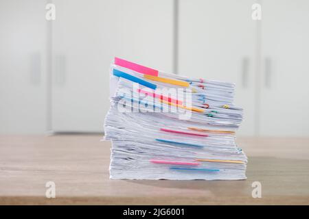 Stack of business paper Businessman working reading documents graph financial to job succes Analyze document plans documents on office desk Stock Photo