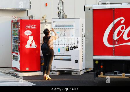 TOKYO, JAPAN - April 12, 2022: Pair of drinks vending machine one stocked with Blue Bottle Coffee products the other a Coca-Cola brand ones by a Coca Stock Photo