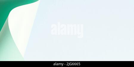 Abstract wave of pastel green paper on light blue background. Creative geometric curved paper with light and shadows. Abstract geometry background Stock Photo