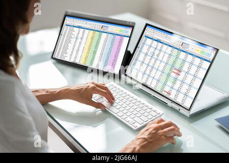 Electronic Spreadsheet Analyst Or Auditor Using Software On Hybrid Laptop Stock Photo