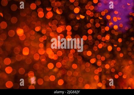 Orange-burgundy highlights, abstract bokeh, red background. Stock Photo