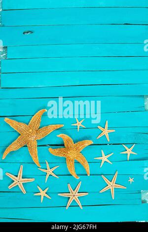 Orange starfish on blue wooden boards. Vacation, travel concept. Copy space Stock Photo