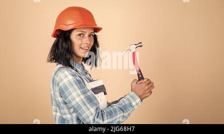 Creating perfection. professional manual worker. technician working using hammer tool. safety uniform. equipment for repairing. mechanic girl in Stock Photo