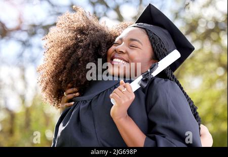 I hope we never lose touch with each other. Shot of a young woman hugging her friend on graduation day. Stock Photo