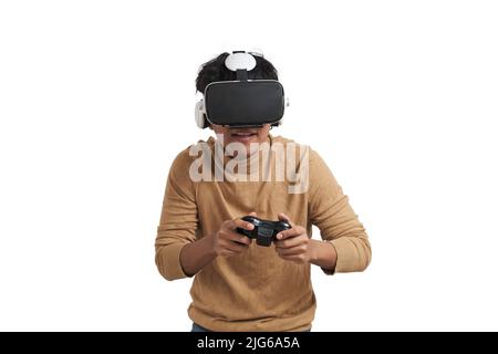 Young peruvian man playing games with joystick and vr headset, isolated. Stock Photo