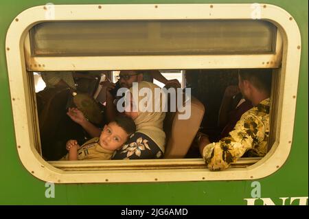 Dhaka. 8th July, 2022. Travelers sitting on a train leave a station in Dhaka, Bangladesh, July 7, 2022. As Eid al-Adha festival approaches, many people from Bangladesh capital Dhaka have streamed out of the city to join the festival with their kith and kin in village homes. Credit: Xinhua/Alamy Live News Stock Photo