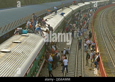 Dhaka. 8th July, 2022. Travelers try to climb up a train at a railway station in Dhaka, Bangladesh, July 7, 2022. As Eid al-Adha festival approaches, many people from Bangladesh capital Dhaka have streamed out of the city to join the festival with their kith and kin in village homes. Credit: Xinhua/Alamy Live News Stock Photo