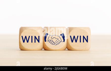 Win Win concept. Text and handshake Icon on wooden blocks. Copy space Stock Photo