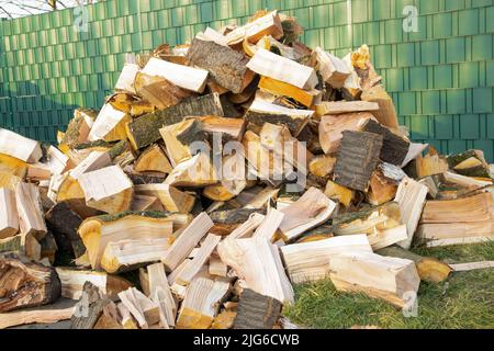 stack of wood, chopped lie stacked on the street. Preparation for the winter for the stove, fireplace Stock Photo