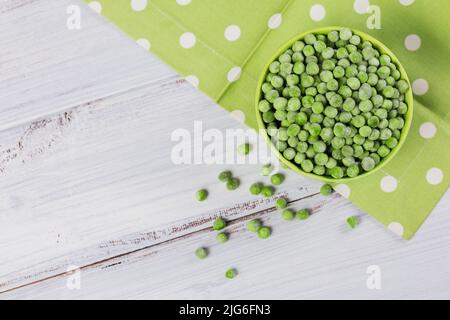 Top view composition with organic frozen vegetables on a white wooden background Stock Photo