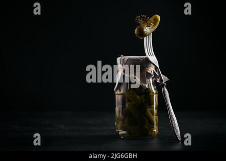 Homemade canning. Marinated cucumbers gherkins with dill and garlic in glass jar Stock Photo