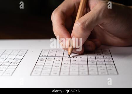 Solving Sudoku puzzle with pencil Stock Photo