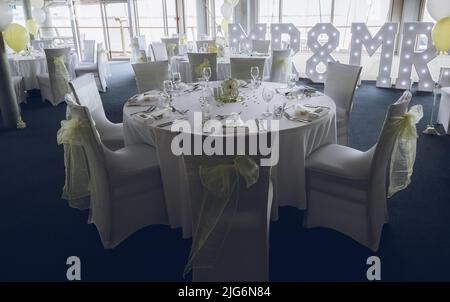 wedding tables set out at a wedding venue ready for a wedding breakfast Stock Photo