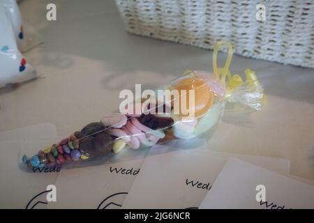 A bag of sweets on a table ready for children attending a wedding Stock Photo