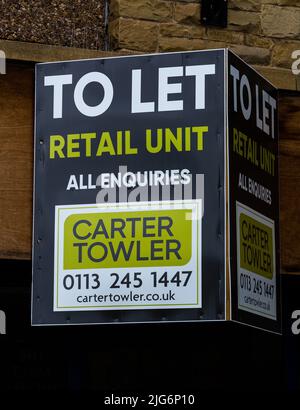 A sign above an empty shop in Baildon, Yorkshire. The retail unit is available to let. Stock Photo