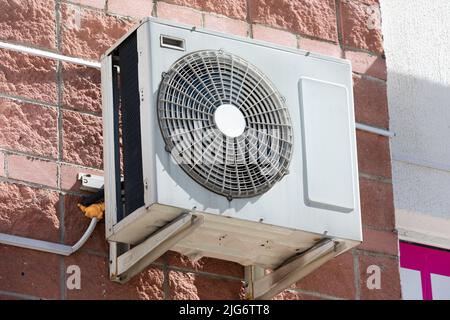 air conditioning unit Central split system hanging outside the building Stock Photo