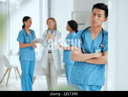 Losing a patient isnt just part of a job. Shot of a medical practitioner looking stressed in the middle of a meeting in hospital. Stock Photo