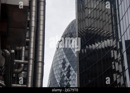 The futuristic Lloyds of London building (l.) and the modern glass and Lloyds of London, in the middle of the Swiss Re Towers, also called The Stock Photo