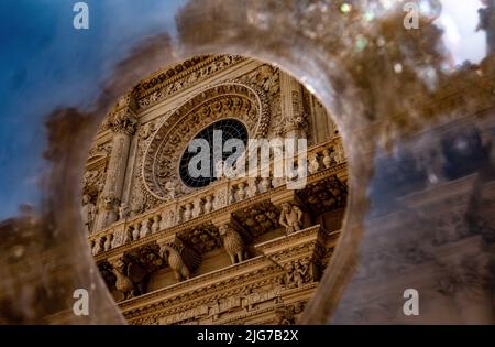 Distorted and abstract view of a Baroque Catholic Church and its rose window along with animal and Saracens holding up the facade Stock Photo