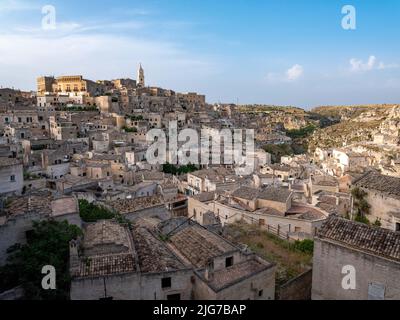 Panoramic view of the sassi or old city of Matera, Basilicata, Italy with its cathedral and cave houses built into the surrounding hills. Stock Photo