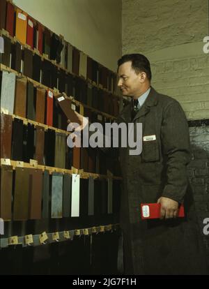 Laboratory worker at the research laboratory at the C &amp; NW RR's [i.e. Chicago and North Western railroad's] 40th Street yard, examining paint samples used on freight cars and coaches of the railroad, Chicago, Ill. Stock Photo