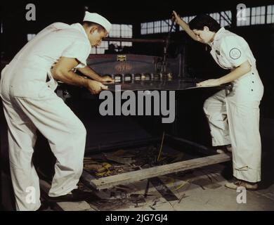 Learning to work a cutting machine, these two NYA employees receive training to fit them for important work, Corpus Christi, Texas. After eight weeks they will be eligible for civil service jobs at the Naval Air Base. Stock Photo