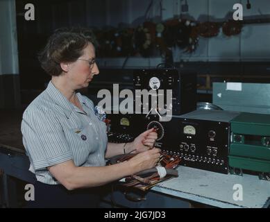 Working with the electric wiring at Douglas Aircraft Company, Long Beach, Calif. Stock Photo