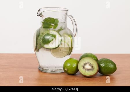 Homemade refreshing natural water flavored with lemon, kiwi and mint leaves. Stock Photo